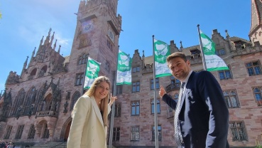 Oberbürgermeister Uwe Conradt und Bürgermeisterin Barbara Meyer vor den Mayors for Peace Flaggen am Rathaus Image